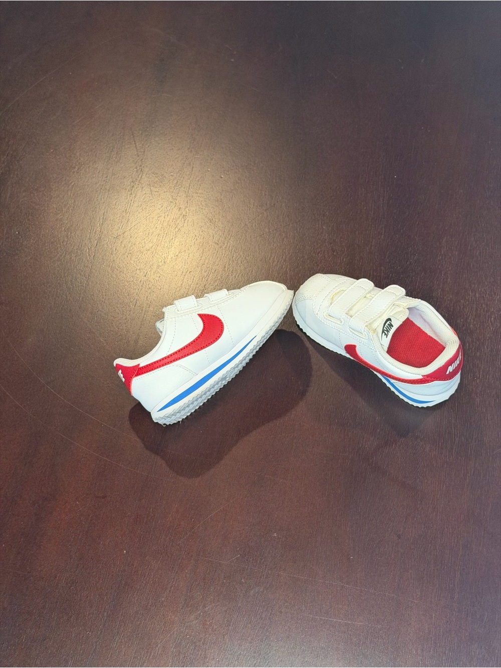 Nike Kids White Sneakers with Red Swoosh and Blue Trim